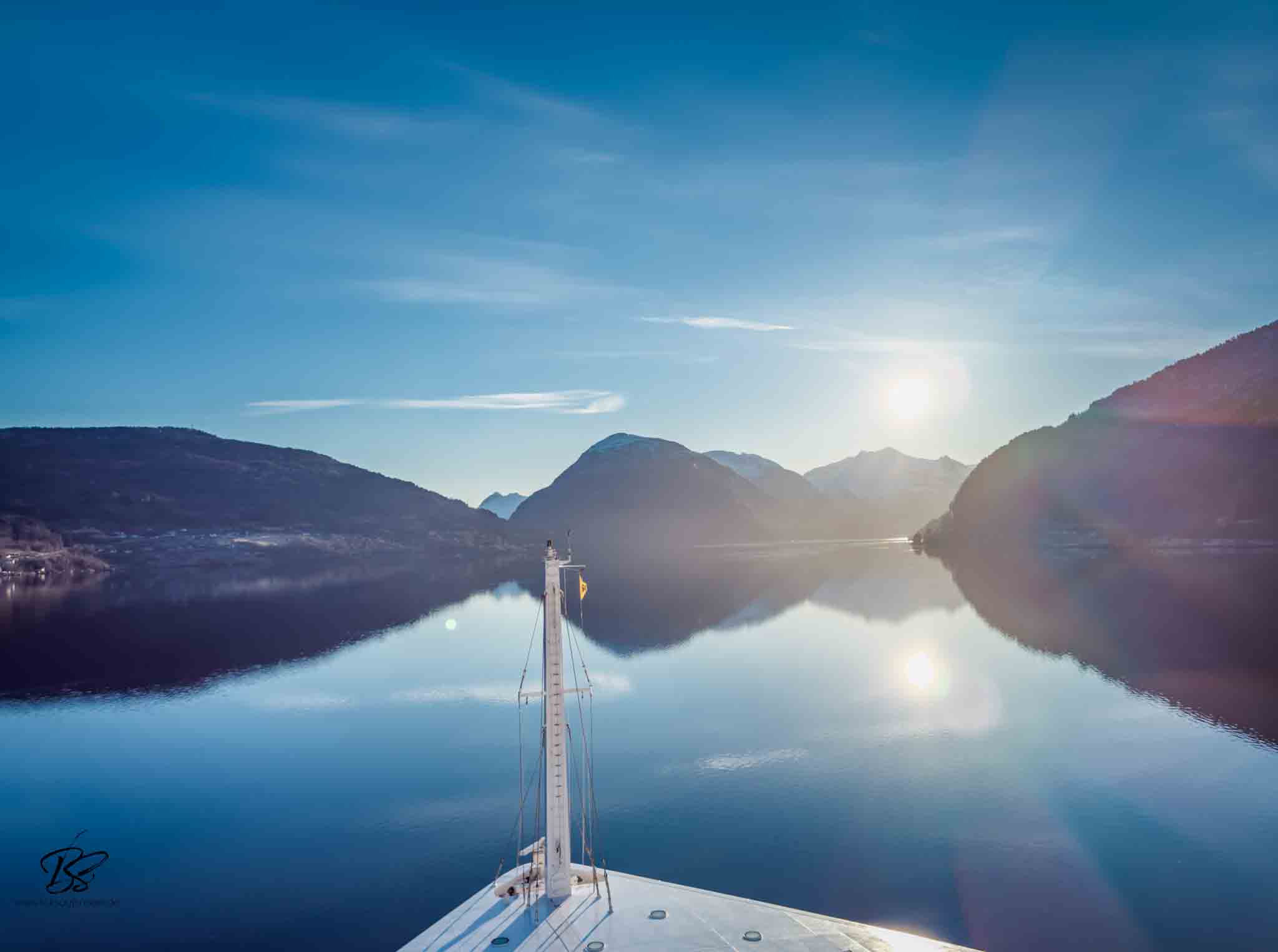 Sailing through the fjord at dawn