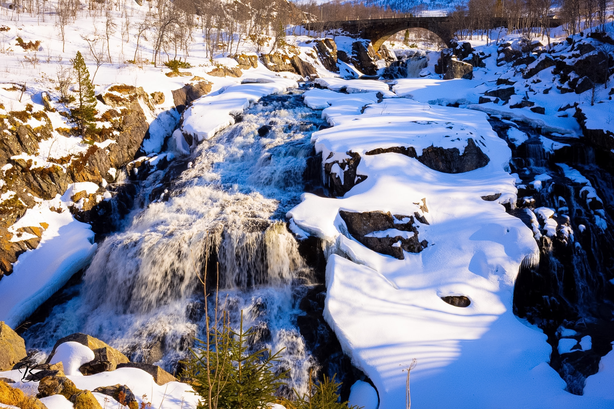 Vøringfossen waterfall with frozen river below and icy paths in April